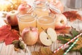 Apple juice, apples and maple leaves Royalty Free Stock Photo