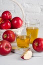 Apple juice in glasses with apples close-up on white table Royalty Free Stock Photo