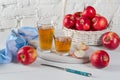 Red apples and juice in glasses and blue napkin on  white table Royalty Free Stock Photo