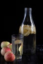 Apple kompot in glass bottle on black the background Royalty Free Stock Photo