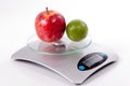 Apple and lemon on kitchen scale Royalty Free Stock Photo