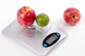 Apple and lemon on kitchen scale Royalty Free Stock Photo