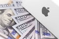 Apple logo on the box, dollars. Apple is a multinational technology company that designs, develops, and sells