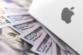 Apple logo on box, money, dollars. Apple is a multinational tech