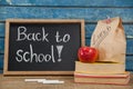 Apple, lunch bag, books and slate with back to school text Royalty Free Stock Photo