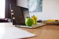 Apple lying on a laptop in the office Royalty Free Stock Photo