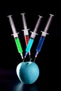 Apple manipulation with syringes Royalty Free Stock Photo