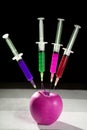 Apple manipulation with syringes Royalty Free Stock Photo