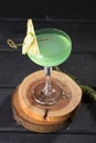 Apple Martini cocktail with garnish on wooden board on black table Royalty Free Stock Photo