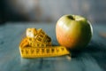 Apple and measuring tape, weight loss diet concept Royalty Free Stock Photo