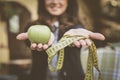 Apple, meter, woman behind. ocus on woman hand. Royalty Free Stock Photo