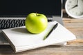 Apple near laptop at workplace, healthy snack. Royalty Free Stock Photo