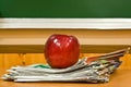 Apple and newspapers Royalty Free Stock Photo