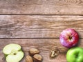 Apple and Nuts Background. Dried walnuts with aple on a wooden background. Royalty Free Stock Photo