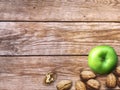 Apple and Nuts Background. Dried walnuts with aple on a wooden background. Royalty Free Stock Photo