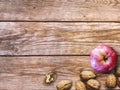 Apple and Nuts Background. Dried walnuts with aple on a wooden background. Royalty Free Stock Photo