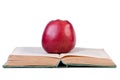 Apple on open old book. Royalty Free Stock Photo