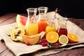 Apple and orange juice -several bottles with fruit and berry juices, vintage wooden background, selective focus Royalty Free Stock Photo