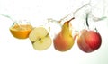 Apple and orange slice and pear splash in water in white background Royalty Free Stock Photo