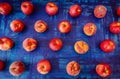 Apple with peach in rows on blue background, raw healhy food concept