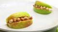 Apple Peanut Butter Monster Mouths on a White Plate. Healthy Halloween Snack