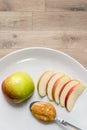 Apple and peanut butter in plate Royalty Free Stock Photo