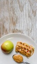 Apple and peanut butter in plate Royalty Free Stock Photo