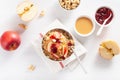 Apple peanut butter quinoa bowl with jam and cashew for healthy breakfast