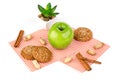 Apple, peanuts and oatmeal cookies on a white table