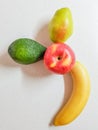 Apple, pear, avocado and banana on the white marble table.