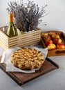 Apple pie and apples. Round homemade cake. Simple pastry made from shortcrust pastry and caramelized apple. Sweet pastries. Still Royalty Free Stock Photo