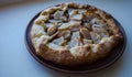 A apple pie on a clay plate on white background Royalty Free Stock Photo
