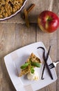 Apple pie with ice cream, decorated with vanilla, mint and cinnamon on wooden background. A delicious piece of cake with ice. Royalty Free Stock Photo