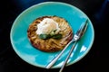 Apple pie with ice cream in a white plate.Warm apple tarte tatin with vanilla ice cream on blue plate. Royalty Free Stock Photo