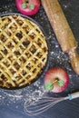 Apple pie with rolling pin and eggbeater