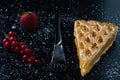 Apple pie slice on black table with currant and strawberry Royalty Free Stock Photo