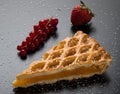 Apple pie slice on black table with currant and strawberry Royalty Free Stock Photo