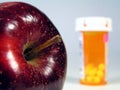 Apple and pill bottle Royalty Free Stock Photo