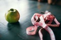 Apple and pink measuring tape, weight loss concept Royalty Free Stock Photo