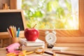 Apple placed on a book with education equipment by the window to morning light, Back to School concept and copy space Royalty Free Stock Photo