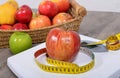 Apple placed on a scales, Royalty Free Stock Photo
