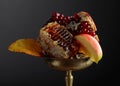 Honeycomb, pomegranate, and apple in an old brass dish
