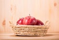 Apple red on basket with wood floor background