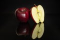 Apple red delicious isolated on black glass