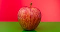 Apple on red and green background