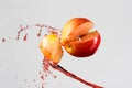 Apple and red juice splash isolated on a gray background Royalty Free Stock Photo