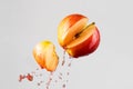 Apple and red juice splash isolated on a gray background Royalty Free Stock Photo