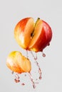 Apple and red juice splash isolated on a gray background Royalty Free Stock Photo