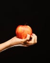 Apple in red and orange color on girls palm. Royalty Free Stock Photo