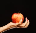 Apple in red and orange color on girls palm. Royalty Free Stock Photo
